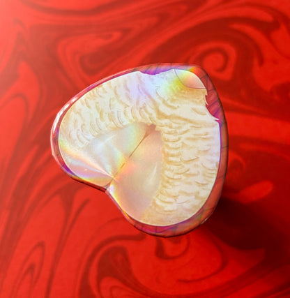 A heart-shaped product with a holo sheen, predominantly white and pink in color. Displays Falin from anime Dungeon Meshi (Delicious In Dungeon)