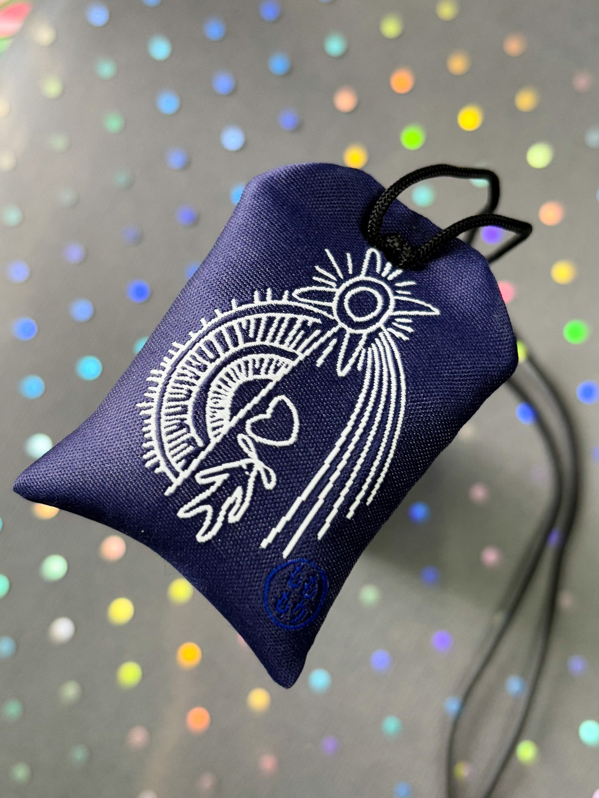 Japanese good luck charm (omamori) based on the Studio Ghibli movie Howl's Moving Castle. Based on the Star Children characters. The back shows Howl's curse mark.