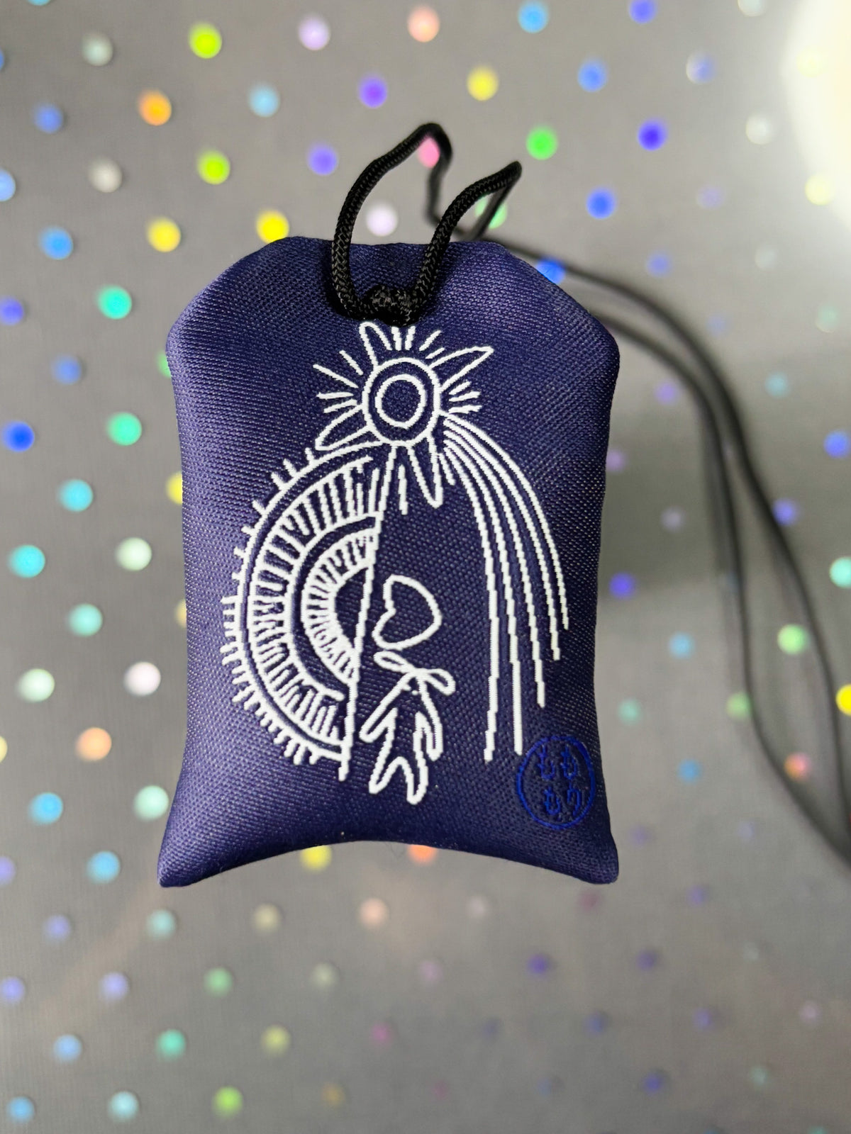 Japanese good luck charm (omamori) based on the Studio Ghibli movie Howl's Moving Castle. Based on the Star Children characters. The back shows Howl's curse mark.